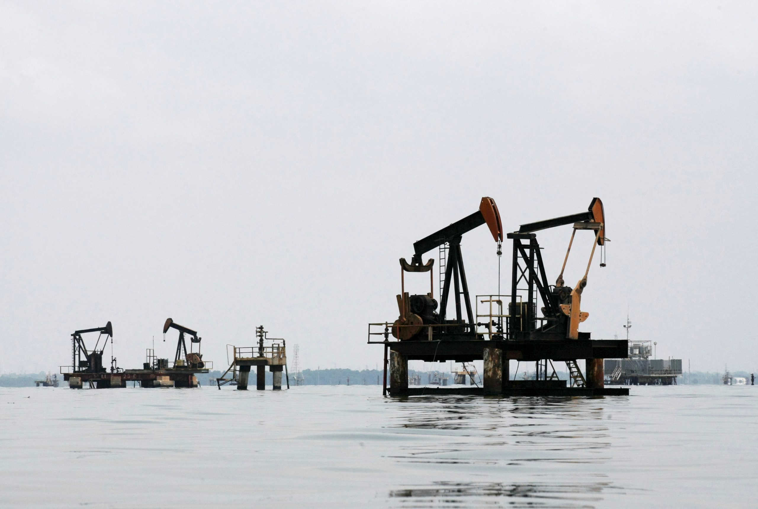 Oil pumps are seen in Lagunillas, Ciudad Ojeda, in Lake Maracaibo in the state of Zulia, Venezuela, March 20, 2015. Venezuela's national crime pandemic - the United Nations says the country has the world's second-highest murder rate after Honduras - is a growing headache for the oil industry, which accounts for nearly all of the country's export revenues. Hold-ups and thefts in the sector are on the rise, taking a toll on output, according to interviews with around 40 people, including oil workers, union leaders, foreign executives, opposition politicians, scrap dealers, and people who live near oil installations. To match Insight VENEZUELA-OIL/CRIME Picture taken on March 20, 2015.  REUTERS/Isaac Urrutia - RTR4YW5C